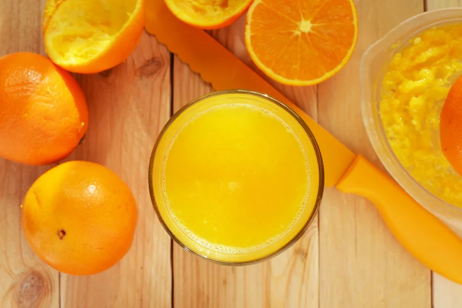 Vitamin B12 Fruits: Truth, Top Sources, and Diet Guide 2 Glass of fortified orange juice with fresh oranges